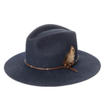 Navy blue felt hat with a brown leather band and feather on a white background